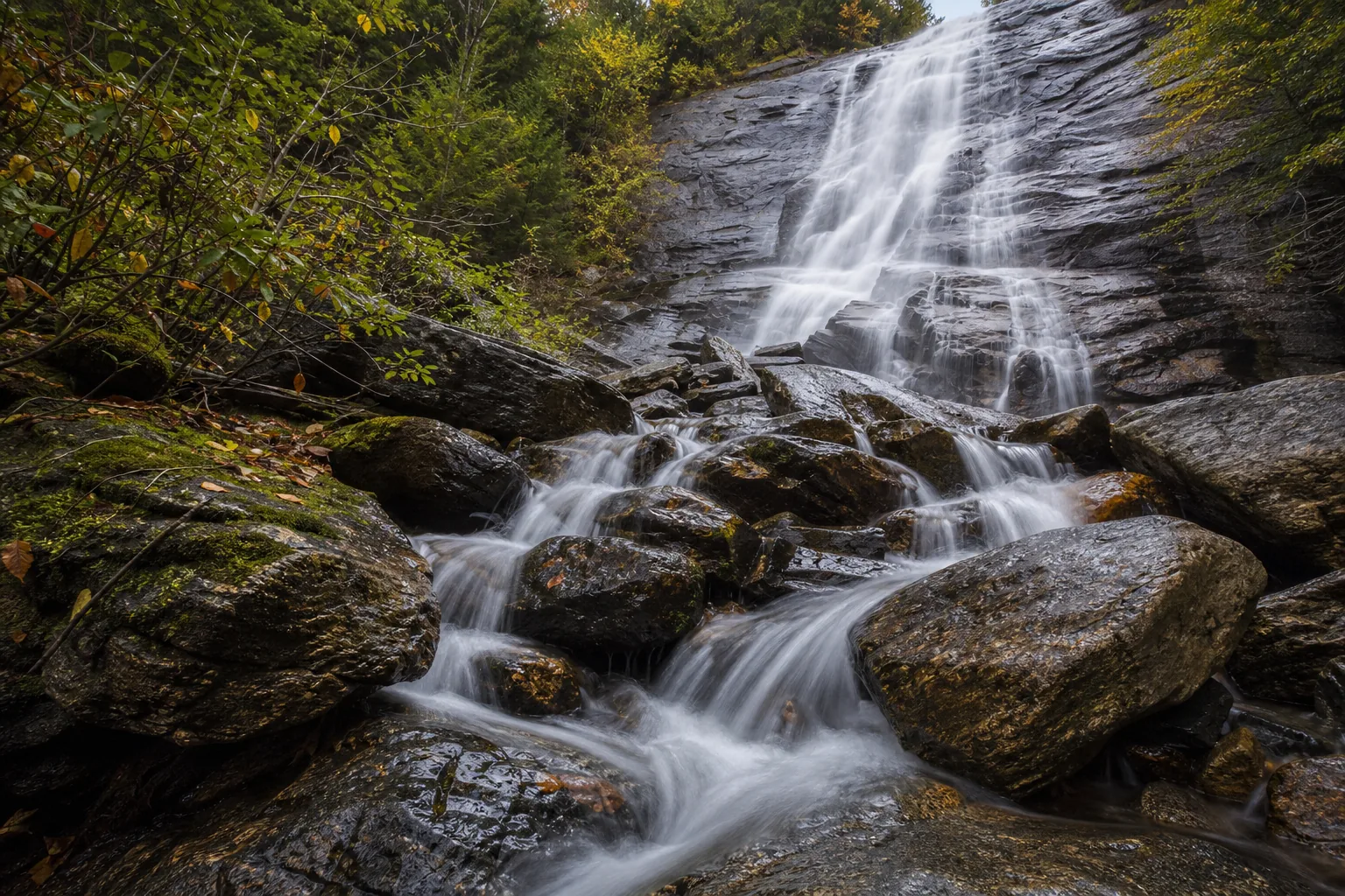Close detail of Arethusa Falls water sliding over Conway Granite in a thin horsetail sheet