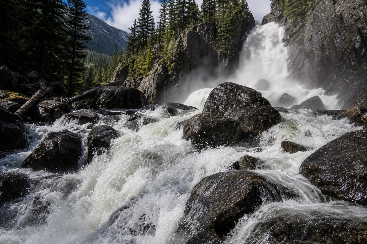 Detailed view of Fish Creek Falls upper tier with water striking polished gneiss before the lower plunge