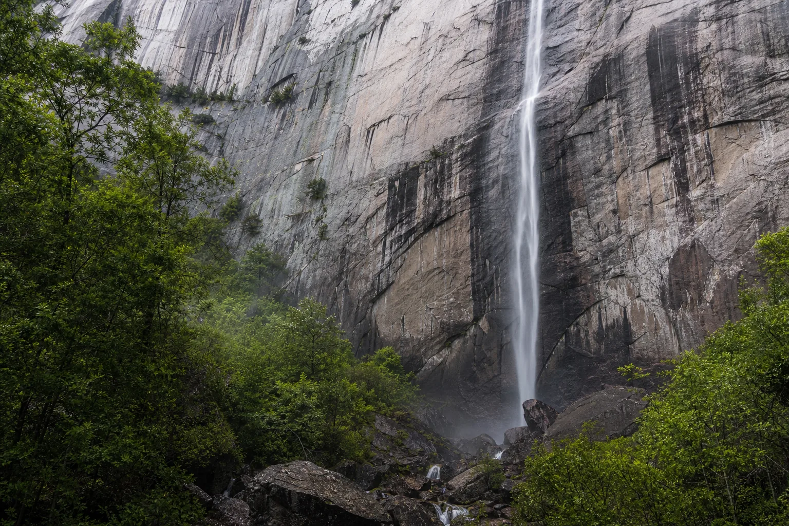 Hickory Nut Falls water cascading over weathered Henderson Gneiss rock detail