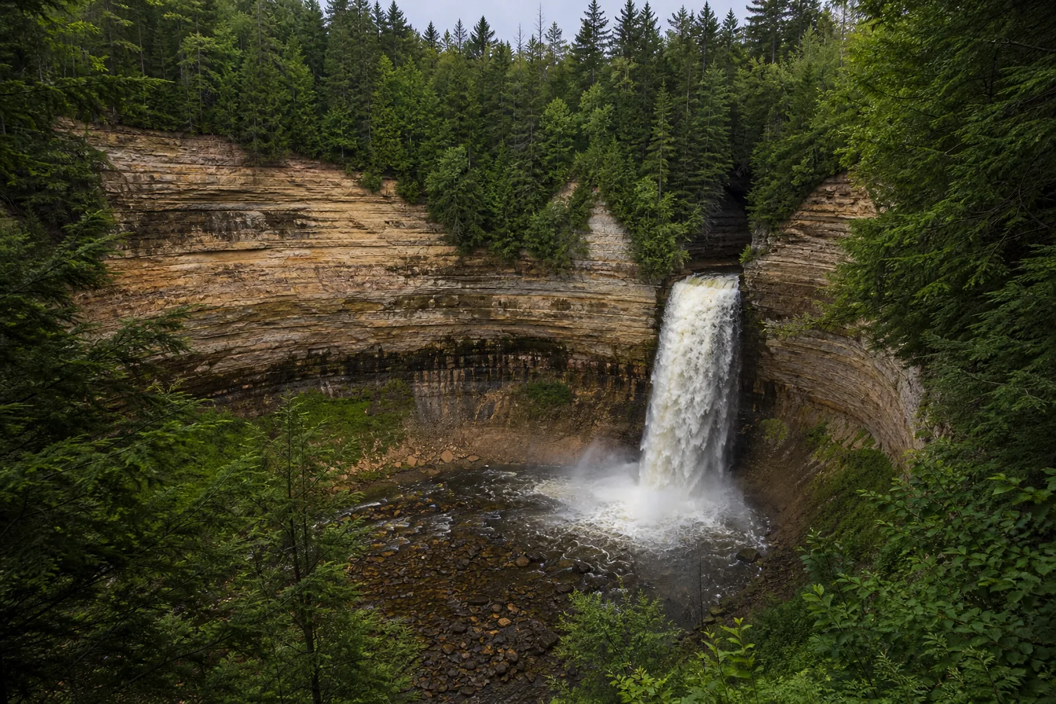 Miners Falls the miners river plunging 50 feet over the cambrian munising formation sandstone, the park's most powerful single-tier waterfall.
