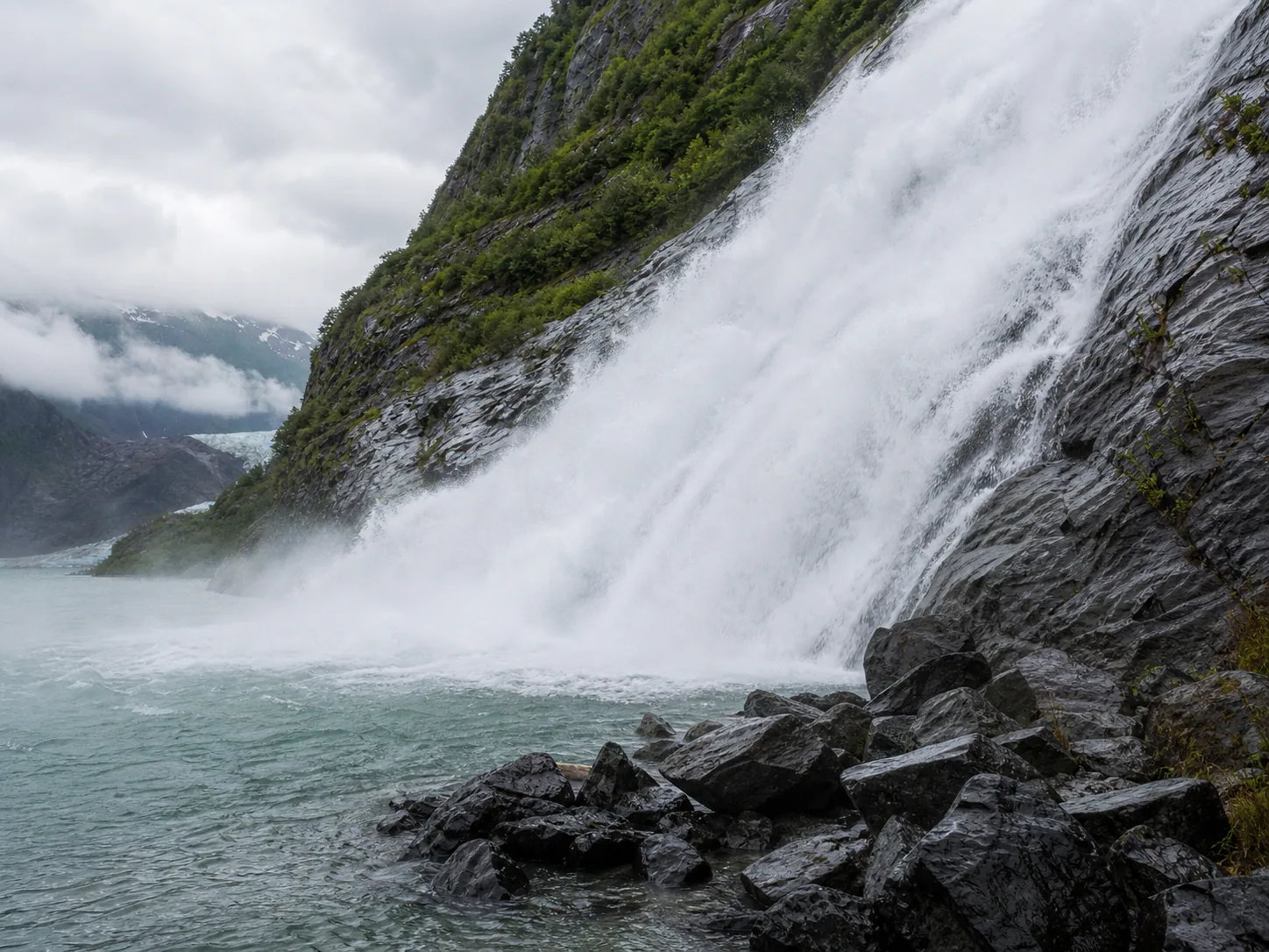 Nugget Falls mid-summer glacial-melt force at the base of the falls