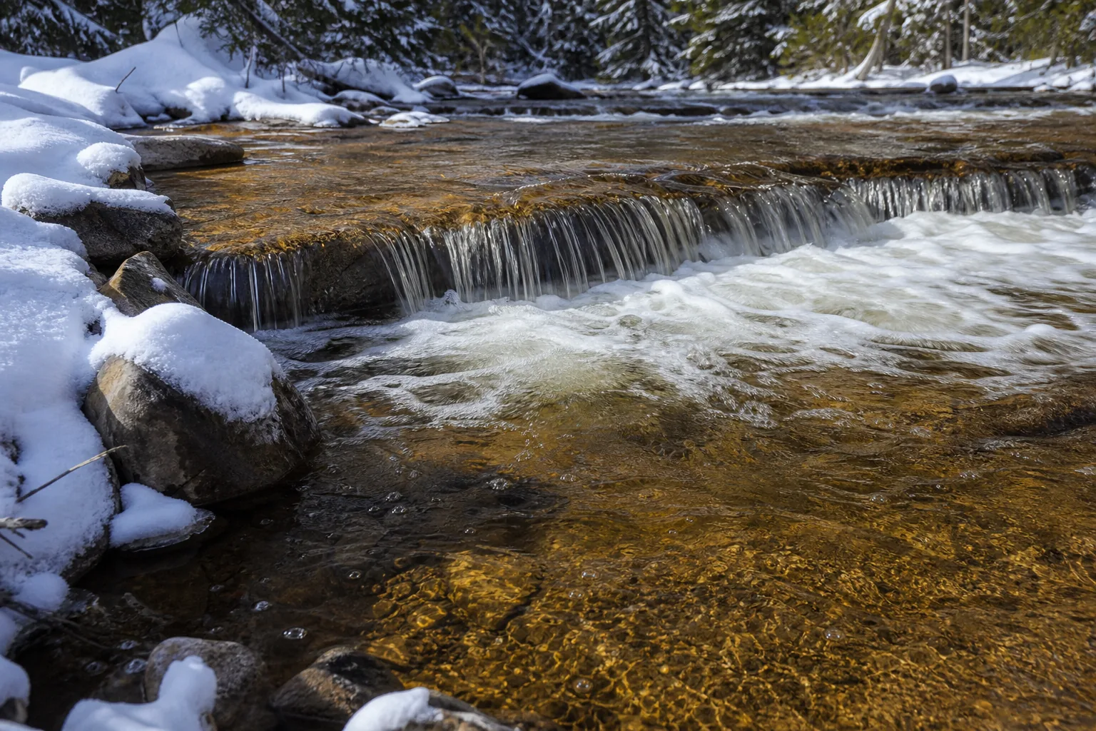 Close water and limestone-ledge detail at Ocqueoc Falls showing the stepped cascade