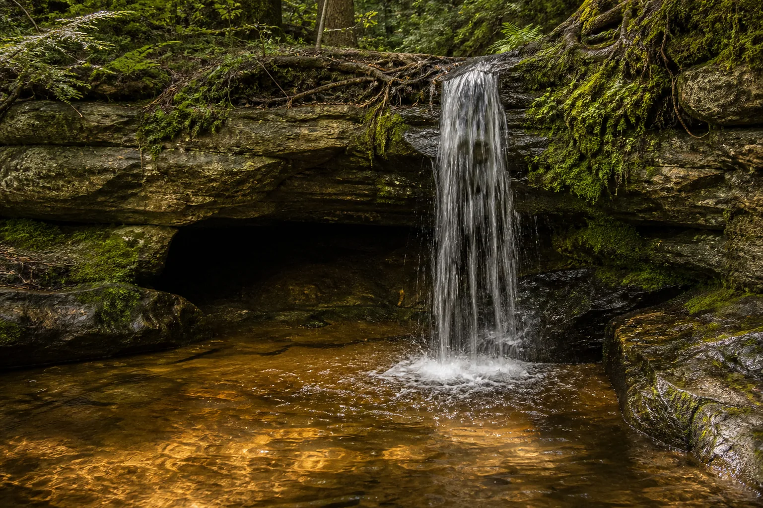 Scott Falls curtain dropping into the sandstone alcove