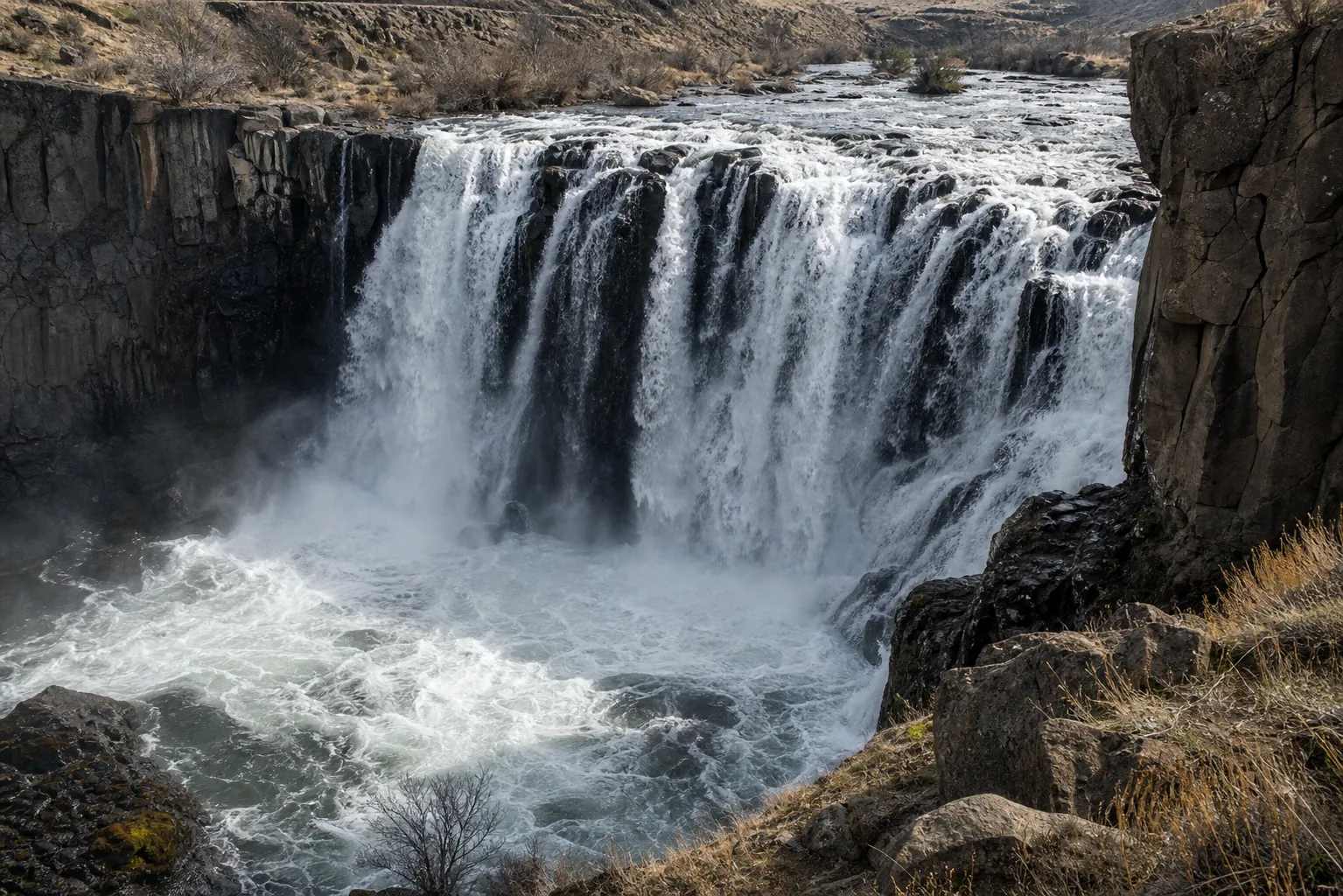 White River Falls base of the falls with mt hood glacial water hitting the basalt apron